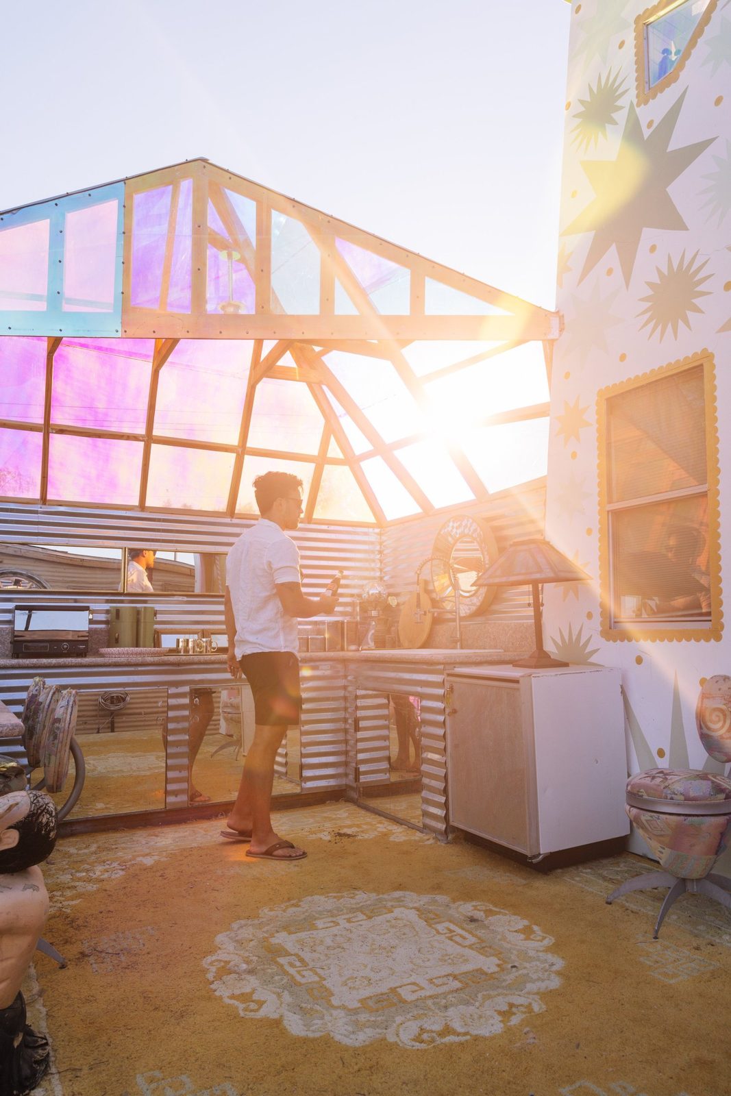 Sunset pouring through the iridescent glass canopy of the open air art kitchen