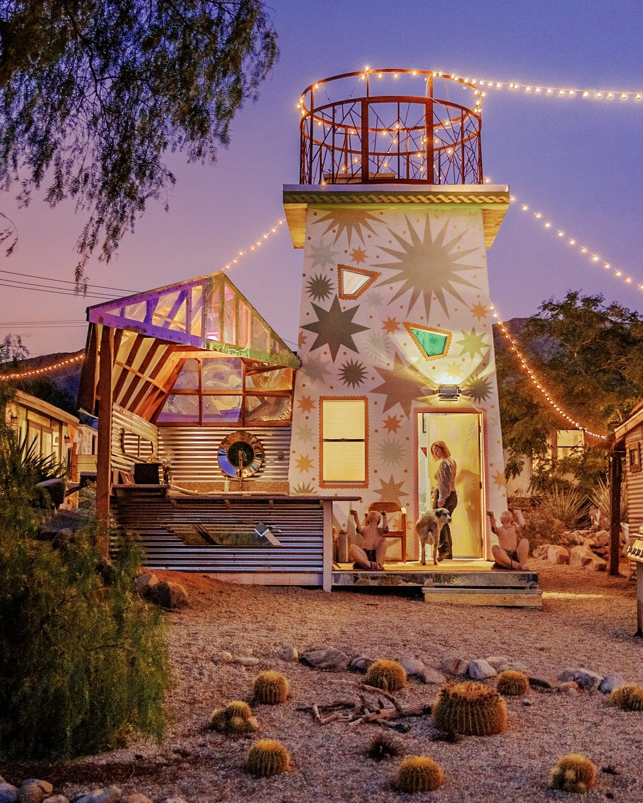 The star painted tower glowing under string lights at dusk